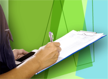 Person writing with a pencil on a clipboard on green geometric background.