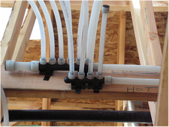 Photo of rough installed mini-manifold supply branches that reduce to multiple smaller diameter "twigs."